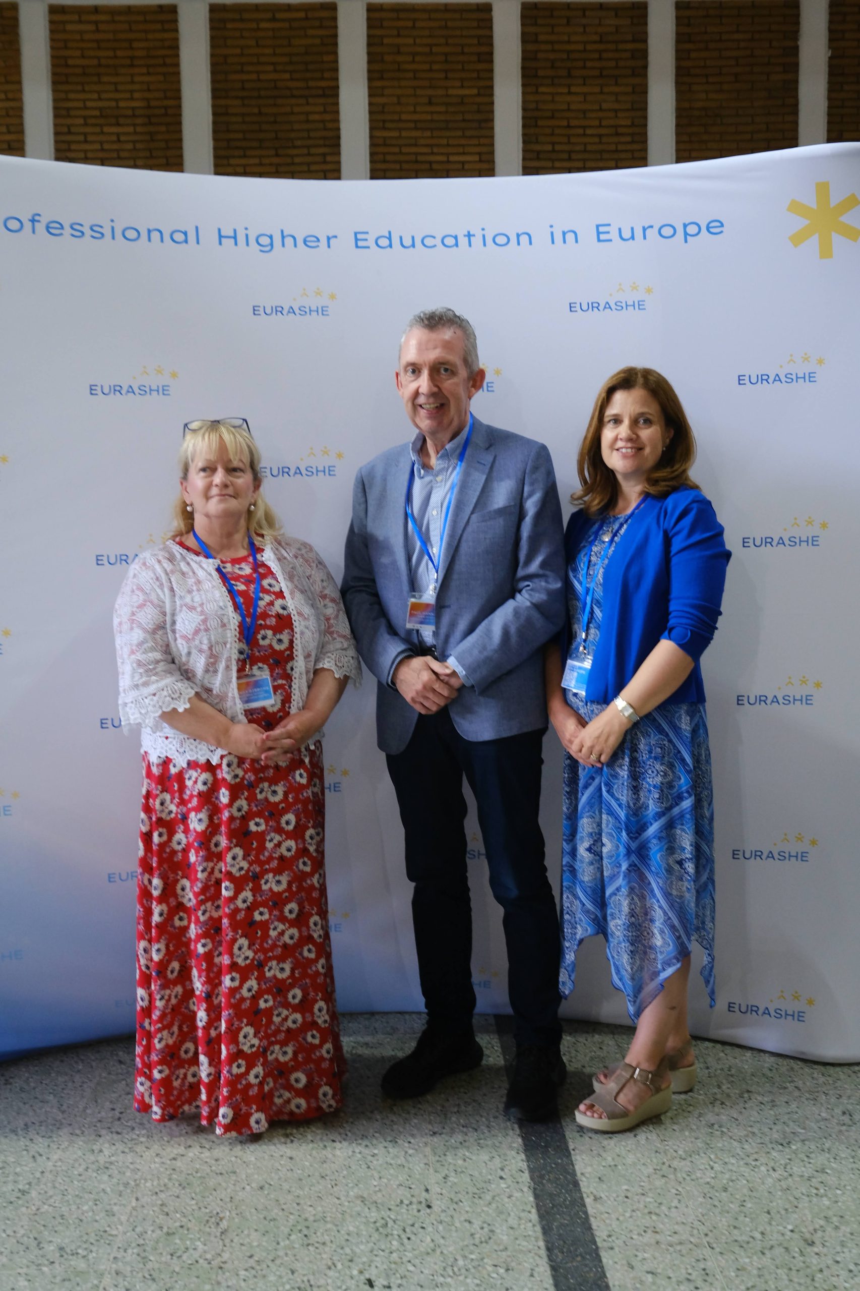 Paul Hannigan featured standing infront of PROFESSIONAL HIGHER EDUCATION IN EUROPE Pull up next to colleagues JoAnne Kilmartin and Wendy Gibbons.